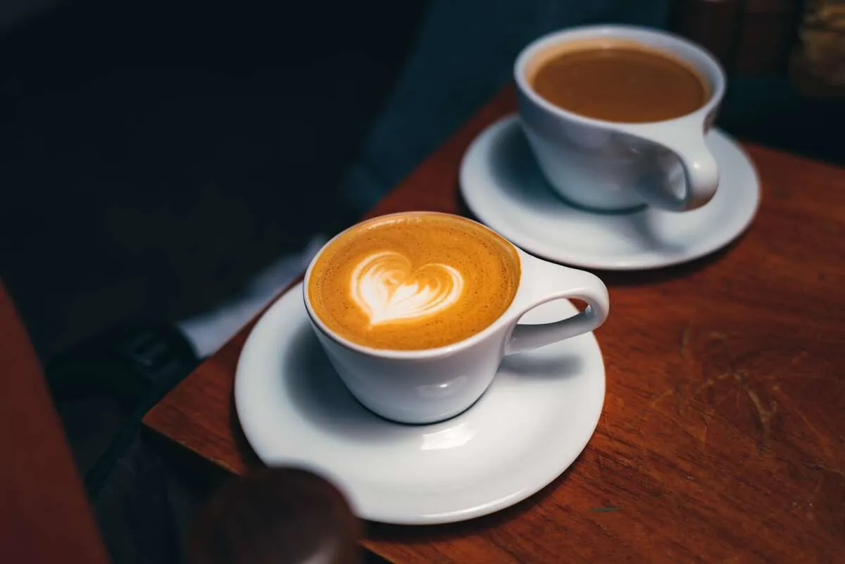 Two cups of coffee on a warm wooden table